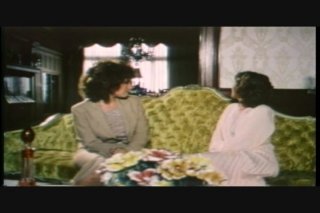 Beautiful Women Sit and Talk on the Couch