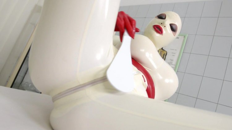 Latex Lucy Is Almost Completely Covered in a Red and White Latex Outfit and Hood As She Masturbates